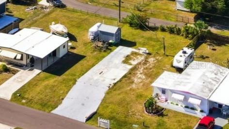 An aerial view shows two mobile homes separated by a concrete driveway and a shed — 1372 IBIS DRIVE, ENGLEWOOD, FL