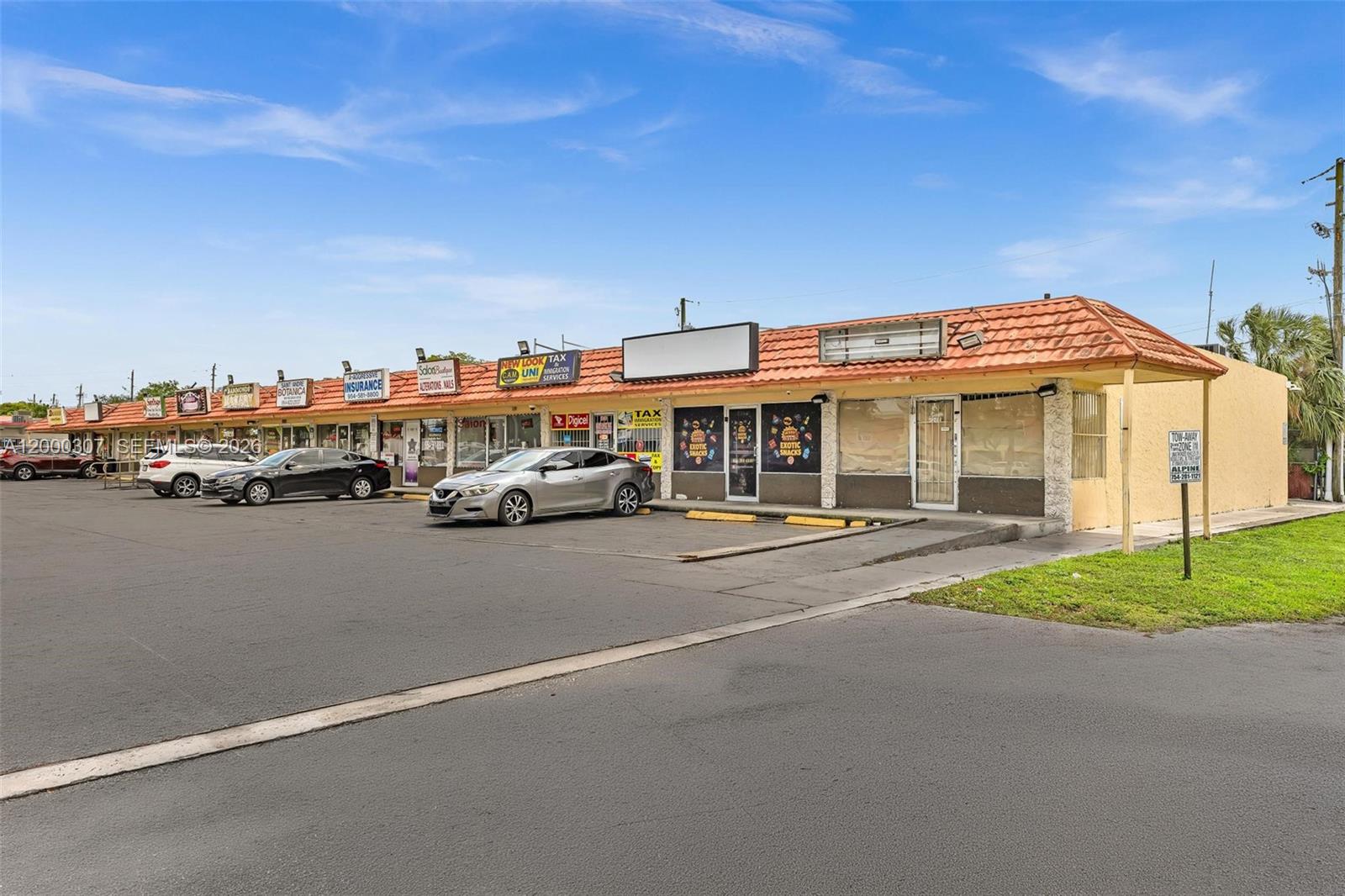 A single-story commercial strip mall with a tiled roof and a parking lot in front — 4200 NW 12th St, Lauderhill FL 33313, LAUDERHILL, FL