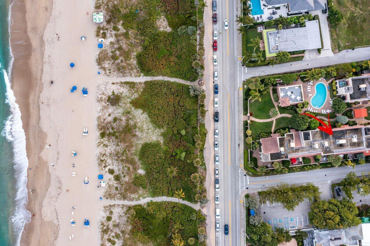 Aerial view of a beachside residential complex with a swimming pool and nearby parking — 200 S Ocean Boulevard # 105, Delray Beach FL 33483, DELRAY BEACH, FL