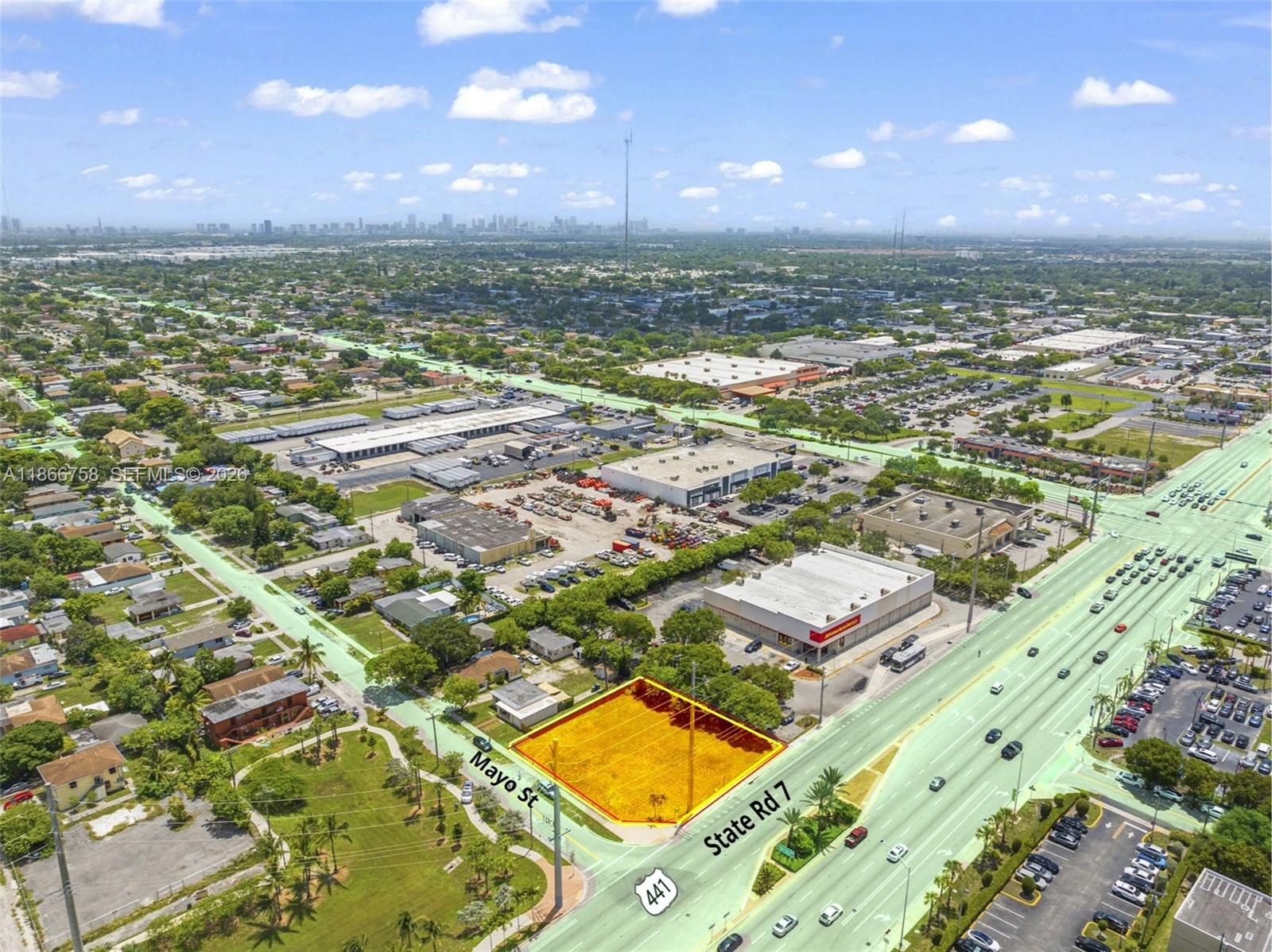 An aerial view shows a vacant rectangular lot highlighted in yellow at a street intersection — 1501 S State Road 7 Rd, Hollywood FL 33023, HOLLYWOOD, FL