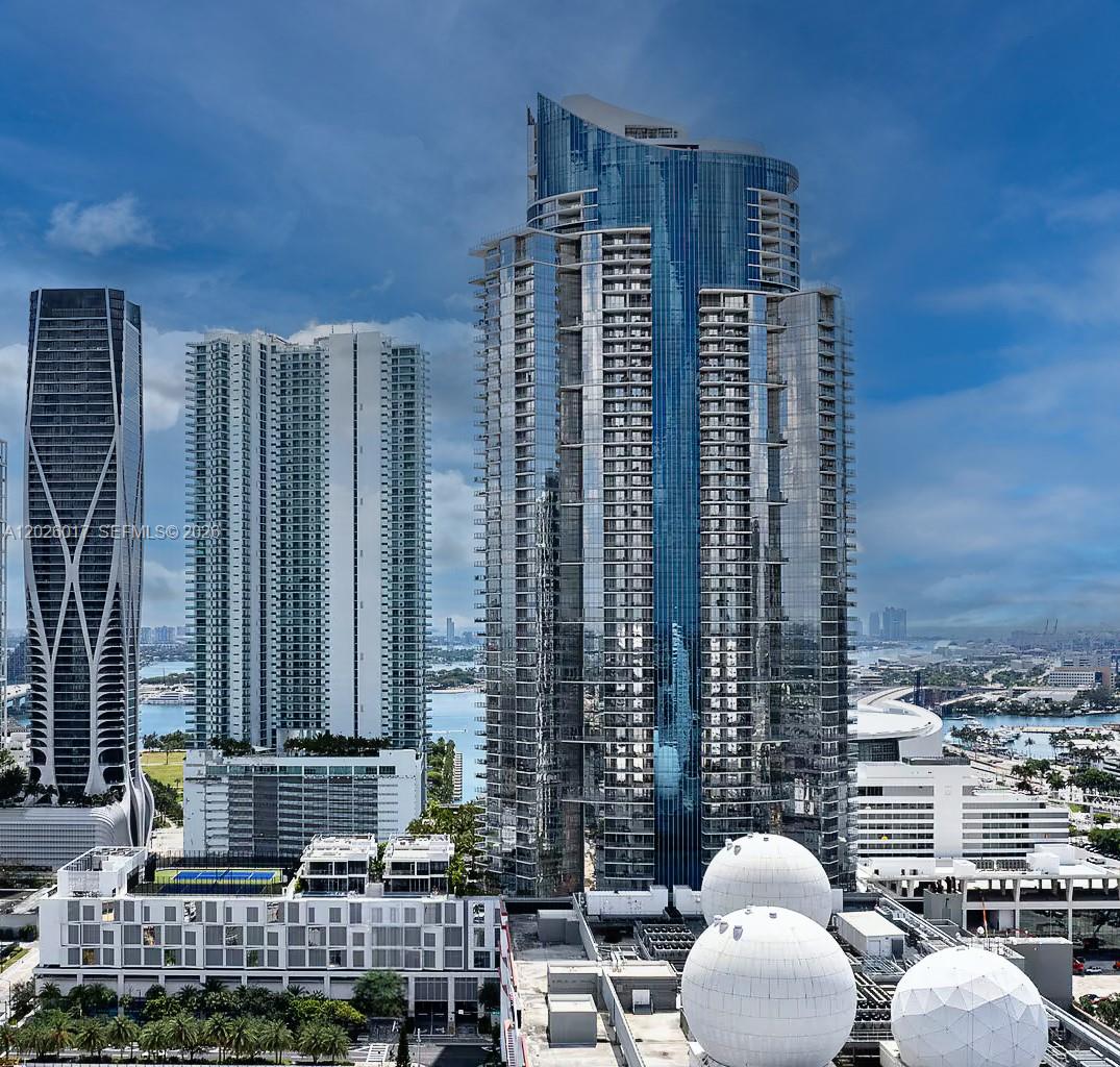 An aerial view shows several modern glass skyscrapers and large white spherical structures — 851 NE 1st Ave # 4201, Miami FL 33132, MIAMI, FL