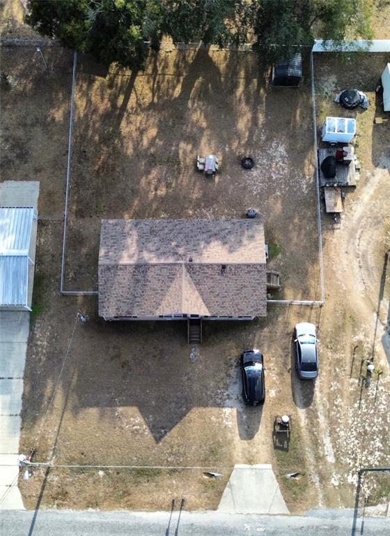 An aerial view shows a house with a fenced backyard, two cars, and a driveway — 16564 SE 103RD AVENUE ROAD, SUMMERFIELD, FL
