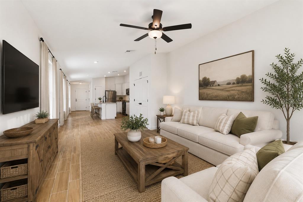 A living room features light-colored sofas, a wooden coffee table, and a view of the kitchen — 5223 CAP ROAD, BROOKSVILLE, FL