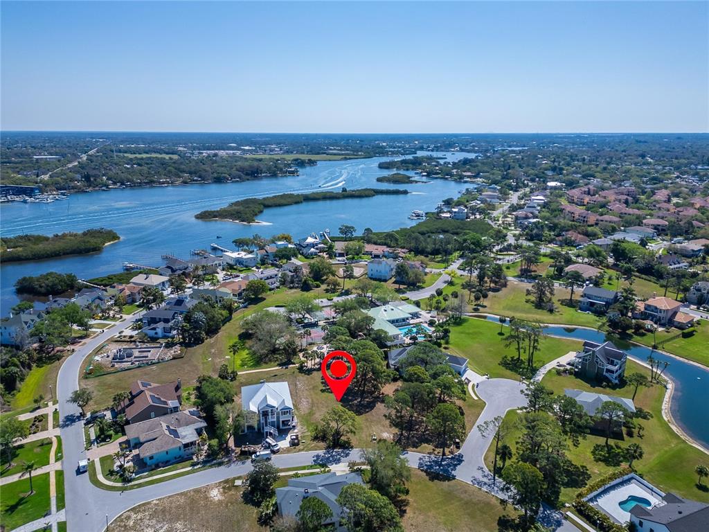 An aerial view shows a residential neighborhood with a red pin marking a vacant lot — HARBOUR WATCH DRIVE, TARPON SPRINGS, FL