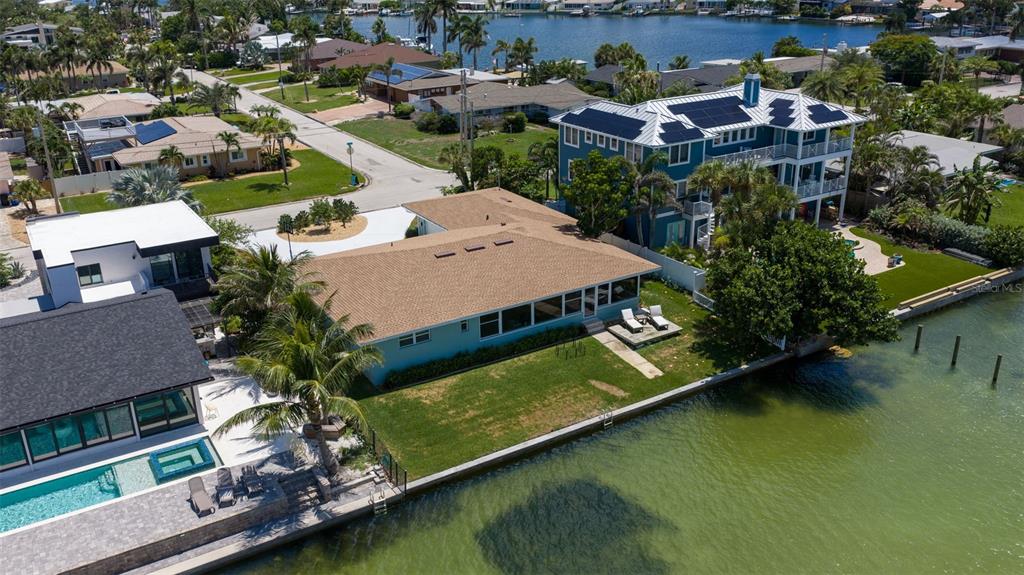 A bright, open-concept living and dining area features light wood flooring and waterfront city views — 501 22ND AVENUE SE, ST PETERSBURG, FL