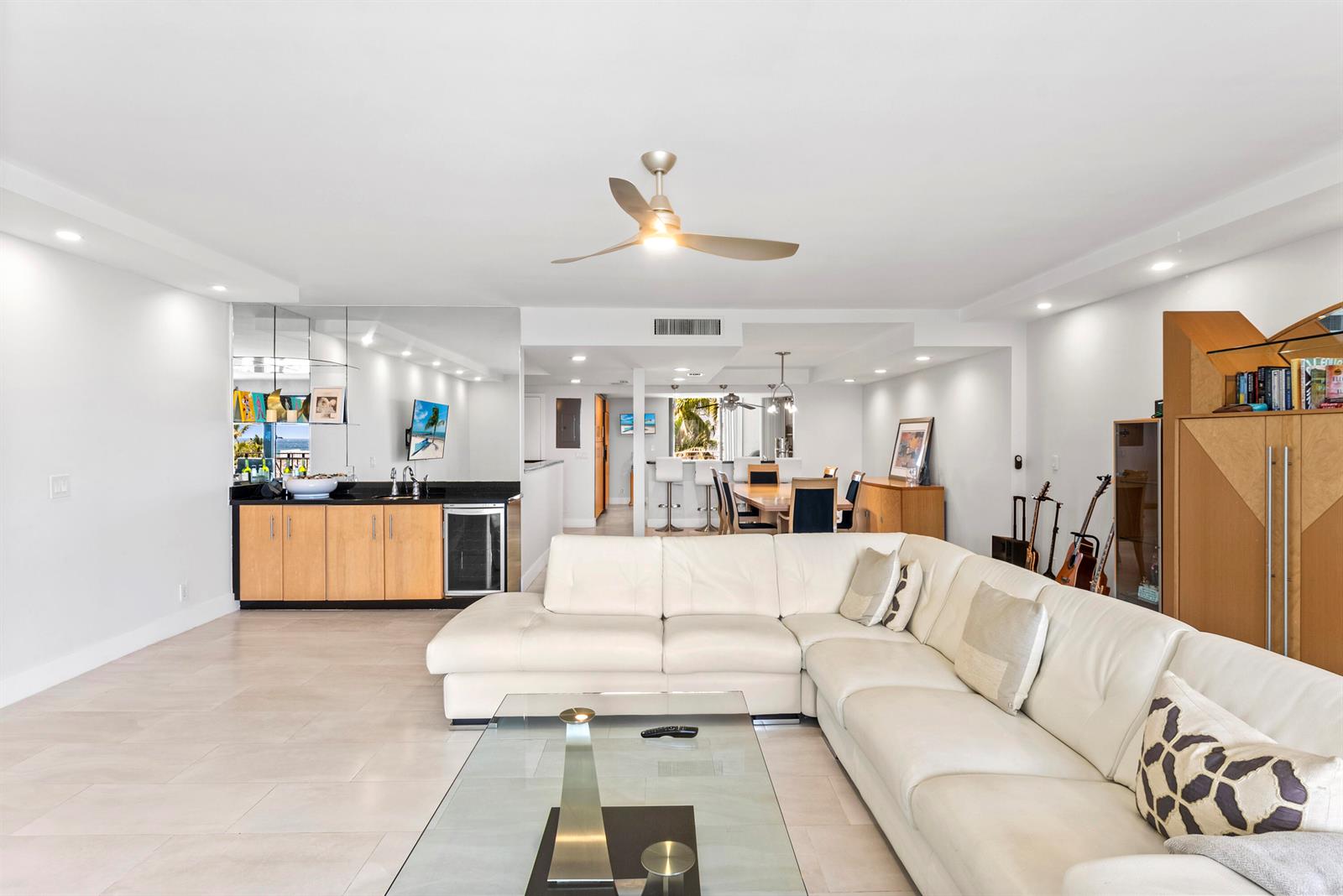 A living room features a white sectional sofa, a glass coffee table, and a wet bar — 2155 S Ocean Boulevard # 11, Delray Beach FL 33483, DELRAY BEACH, FL