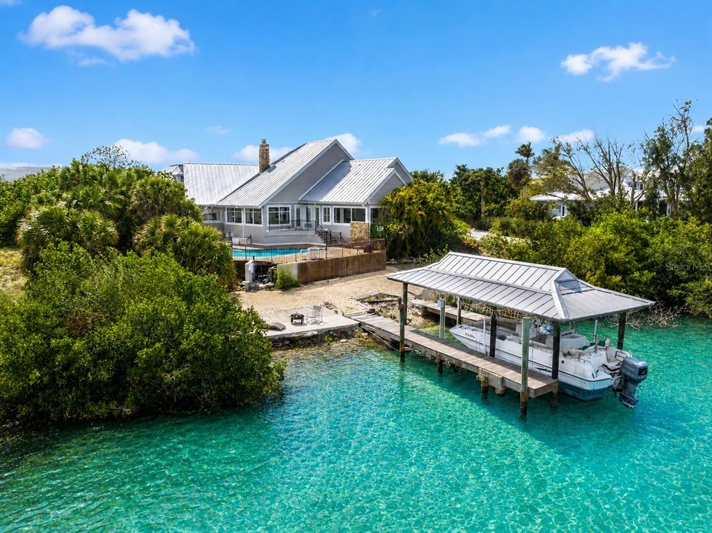 A waterfront house with a metal roof, swimming pool, and private boat dock — 4024 CASEY KEY ROAD, NOKOMIS, FL