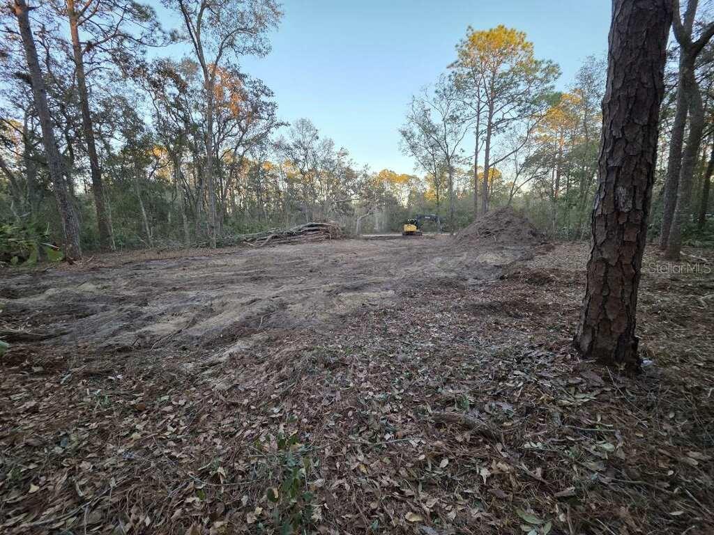 A cleared, wooded lot features a pile of dirt and a piece of construction equipment — 129 SEMINOLE AVENUE, INTERLACHEN, FL
