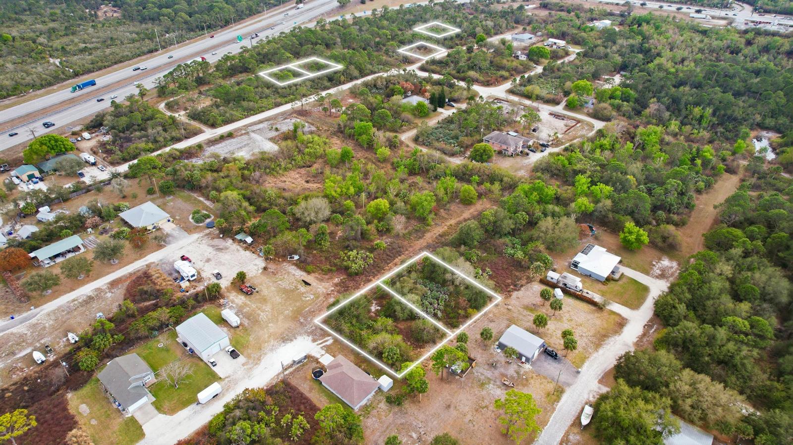 An aerial view shows several residential lots outlined in white within a wooded area — 2145 94th Avenue, Vero Beach FL 32966, VERO BEACH, FL