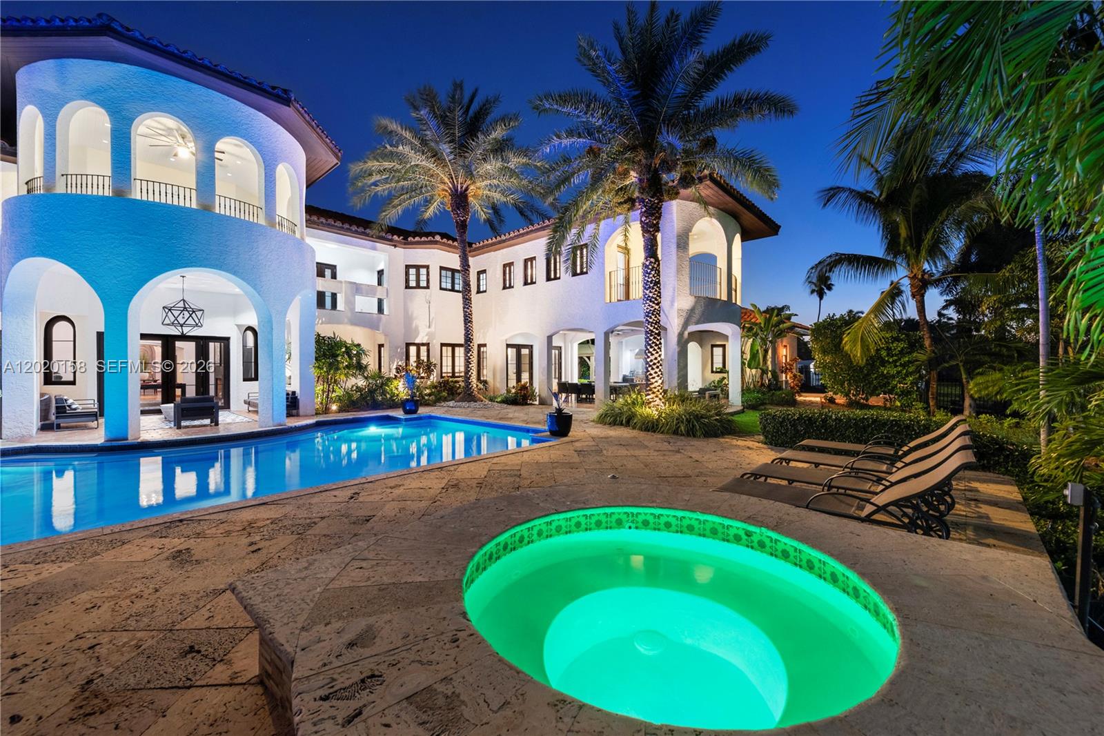 A two-story white Mediterranean-style house features a swimming pool and a glowing circular hot tub — 1201 NE 83rd St, Miami FL 33138, MIAMI, FL