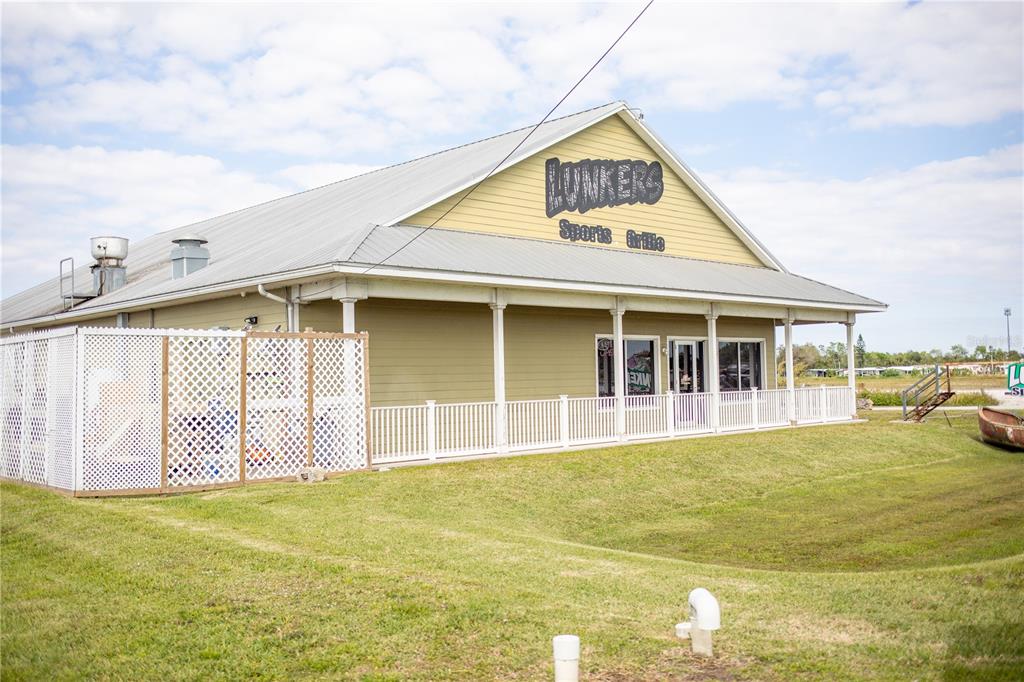 The exterior of a light green building with a metal roof and white lattice fencing — 4825 S U S 441 HIGHWAY S, OKEECHOBEE, FL