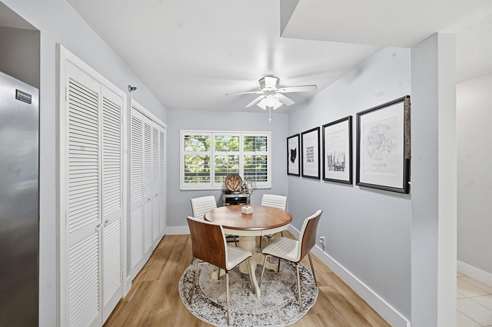 A dining area features a round wooden table, four chairs, and framed wall art — 500 Ocean Trail Way # 207, Jupiter FL 33477, JUPITER, FL