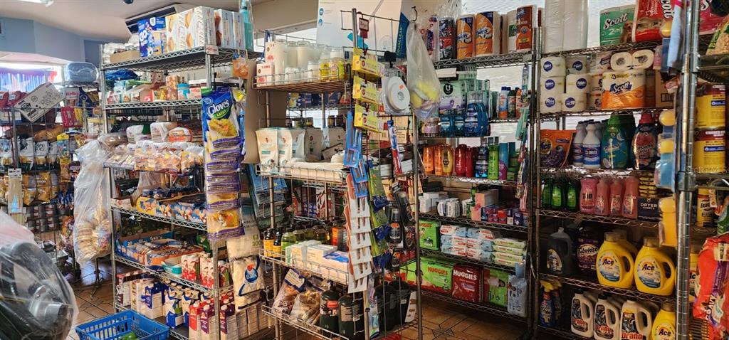 Shelves in a store are stocked with various household goods, cleaning supplies, and food items — Carr. 414, Km 3.6 BO. RÍO GRANDE, RINCON, PR