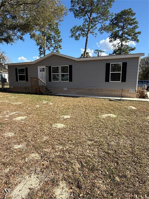 A single-story house with a screened porch and a car parked in the driveway — 8325 N FAIRGROVE TERRACE, DUNNELLON, FL