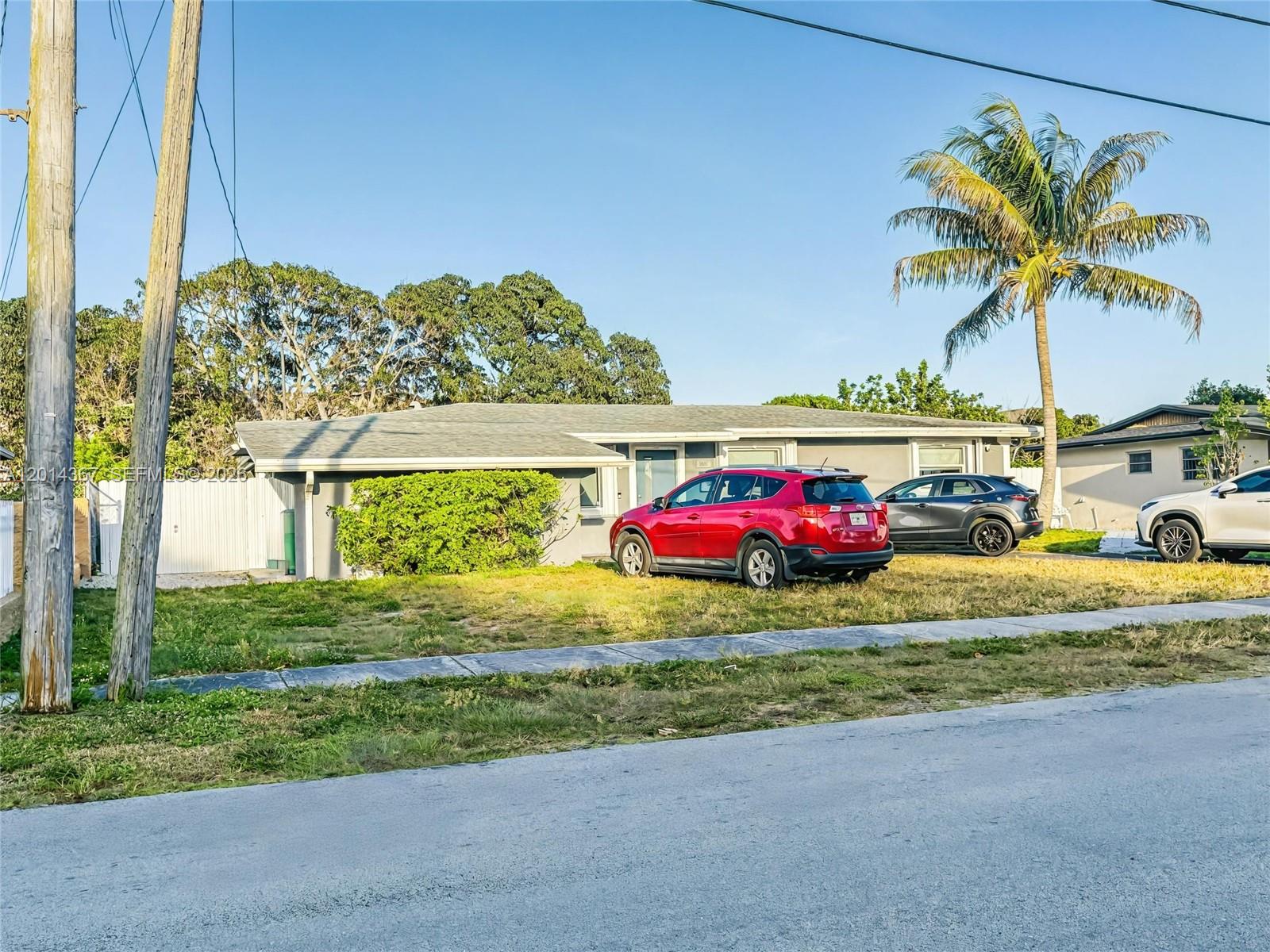 A single-story house with a gray exterior, a red SUV, and a palm tree — 18901 NW 28th Pl, Miami Gardens FL 33056, MIAMI GARDENS, FL
