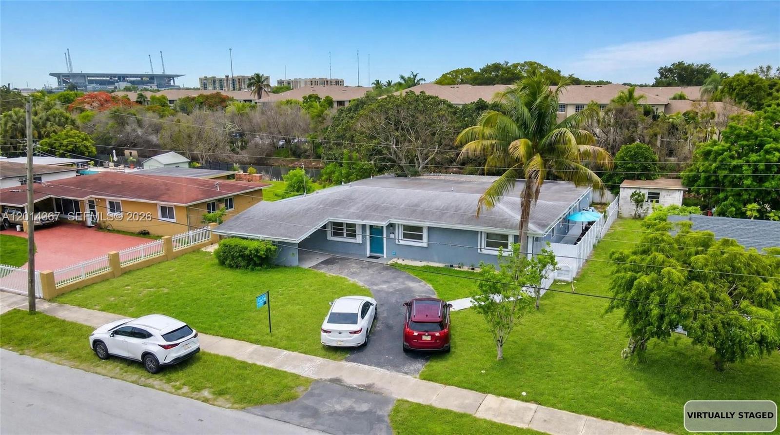 An aerial view shows a gray single-story house with a driveway and a front lawn — 18901 NW 28th Pl, Miami Gardens FL 33056, MIAMI GARDENS, FL