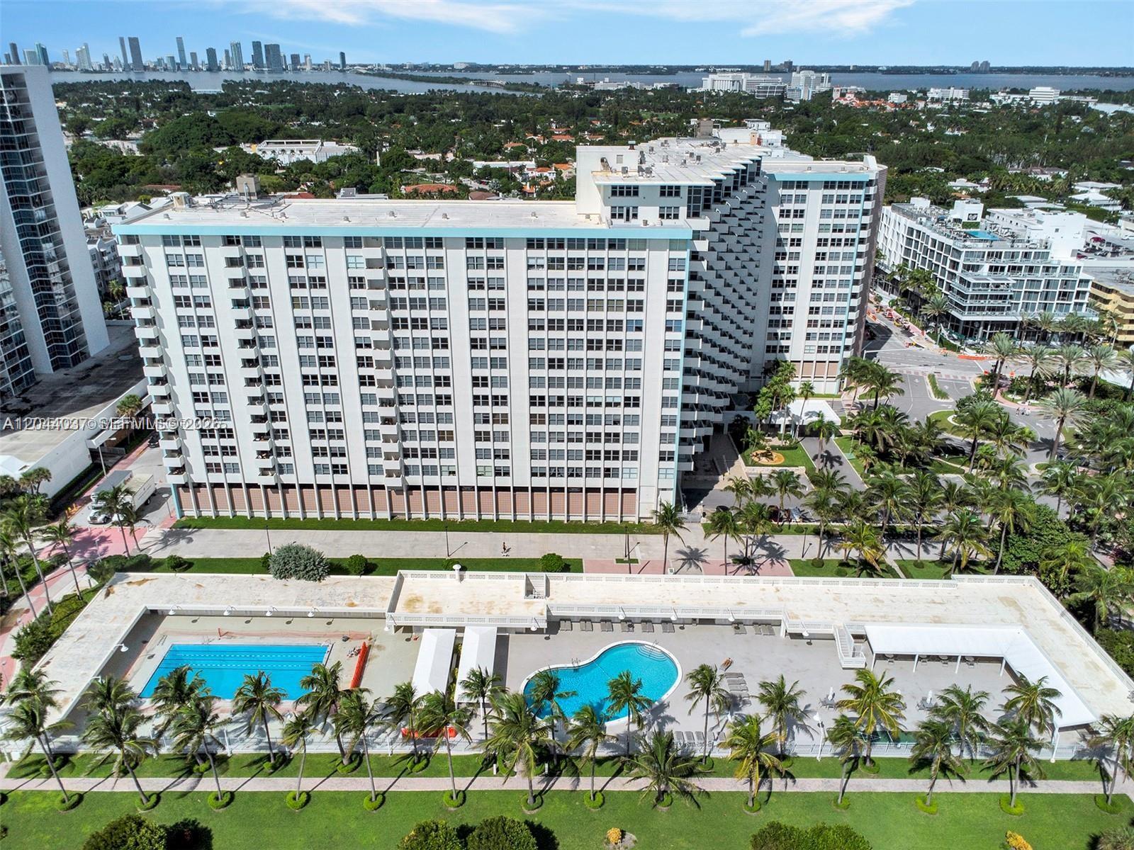 An aerial view shows a large apartment building with two swimming pools in the foreground — 2899 Collins Ave # 1726, Miami Beach FL 33140, MIAMI BEACH, FL