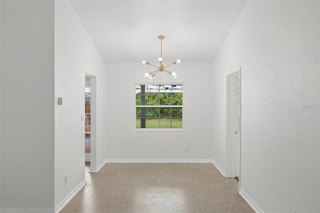 A single-story house exterior features gray horizontal siding, a brick facade, and a white door — 724 BRAIDWOOD LANE, ORLANDO, FL