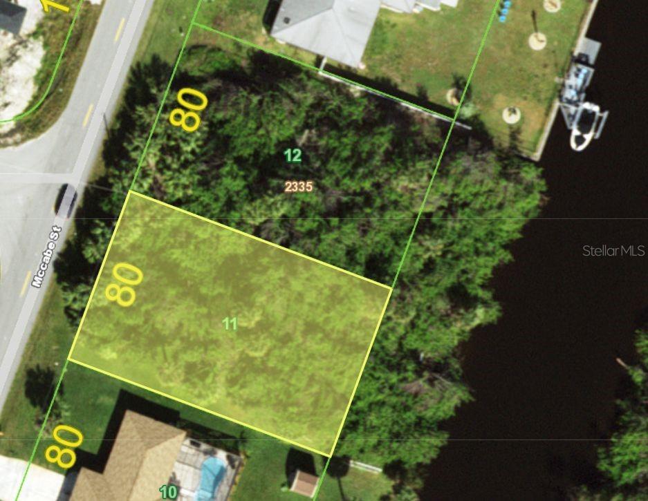 This is an aerial map showing a highlighted residential lot along a canal — 496 MCCABE STREET, PORT CHARLOTTE, FL