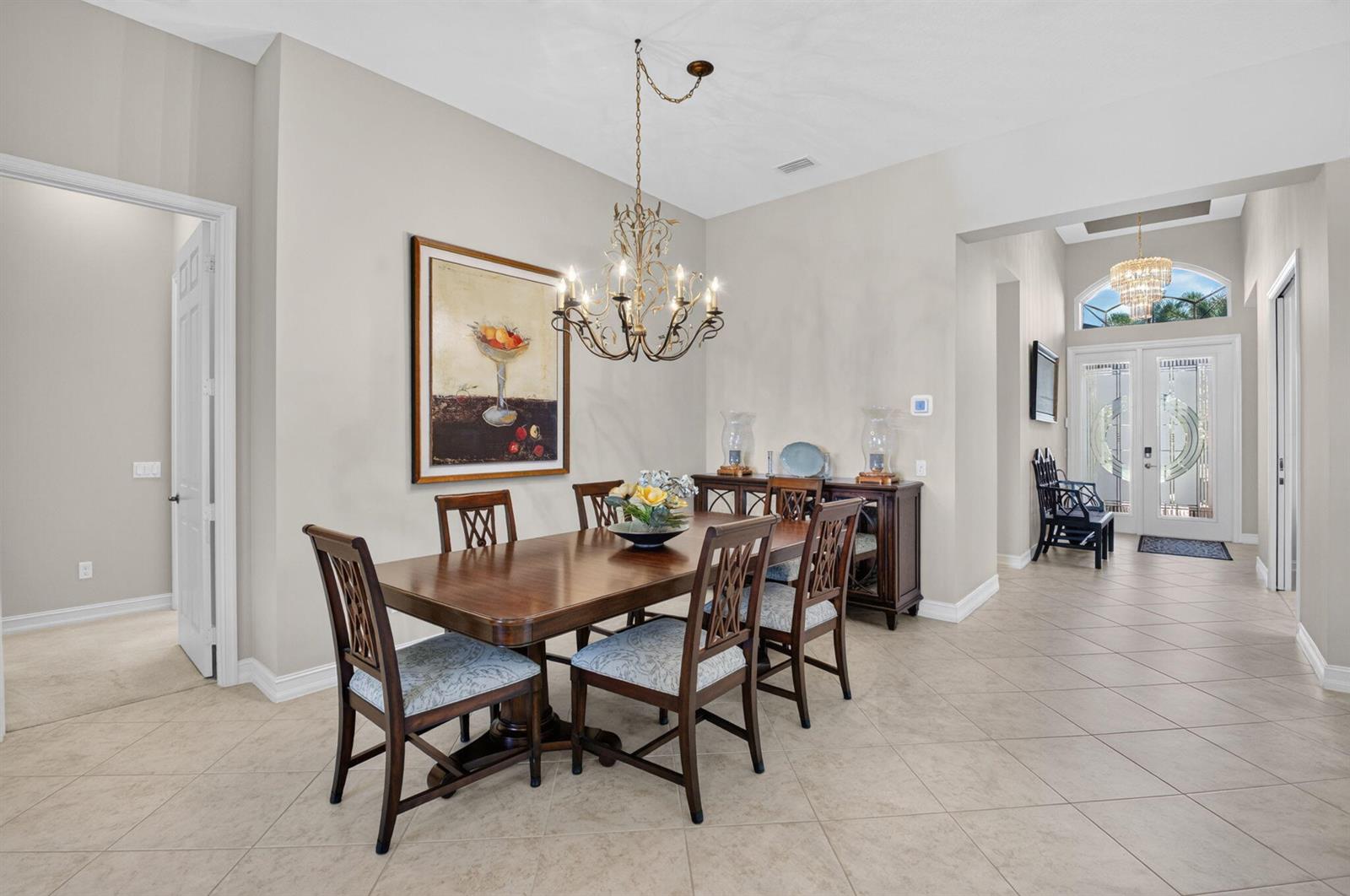 A dining room with a wooden table, six chairs, a chandelier, and tile flooring — 10830 Leaf Bridge Way, Boynton Beach FL 33473, BOYNTON BEACH, FL