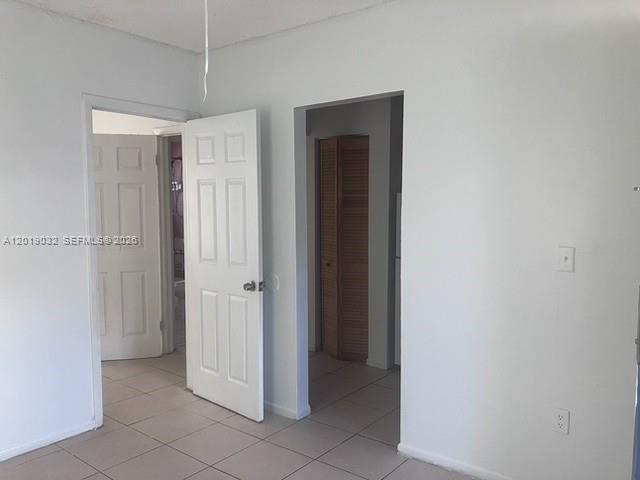 An interior view shows a room with white walls, tiled floors, and two open doorways — 3698 William Ave # 6, Miami FL 33133, MIAMI, FL