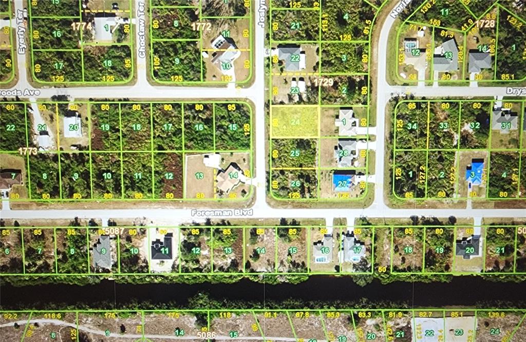This is an aerial map showing residential lots, streets, and houses in a neighborhood — 5630 JOSLYN TERRACE, PORT CHARLOTTE, FL