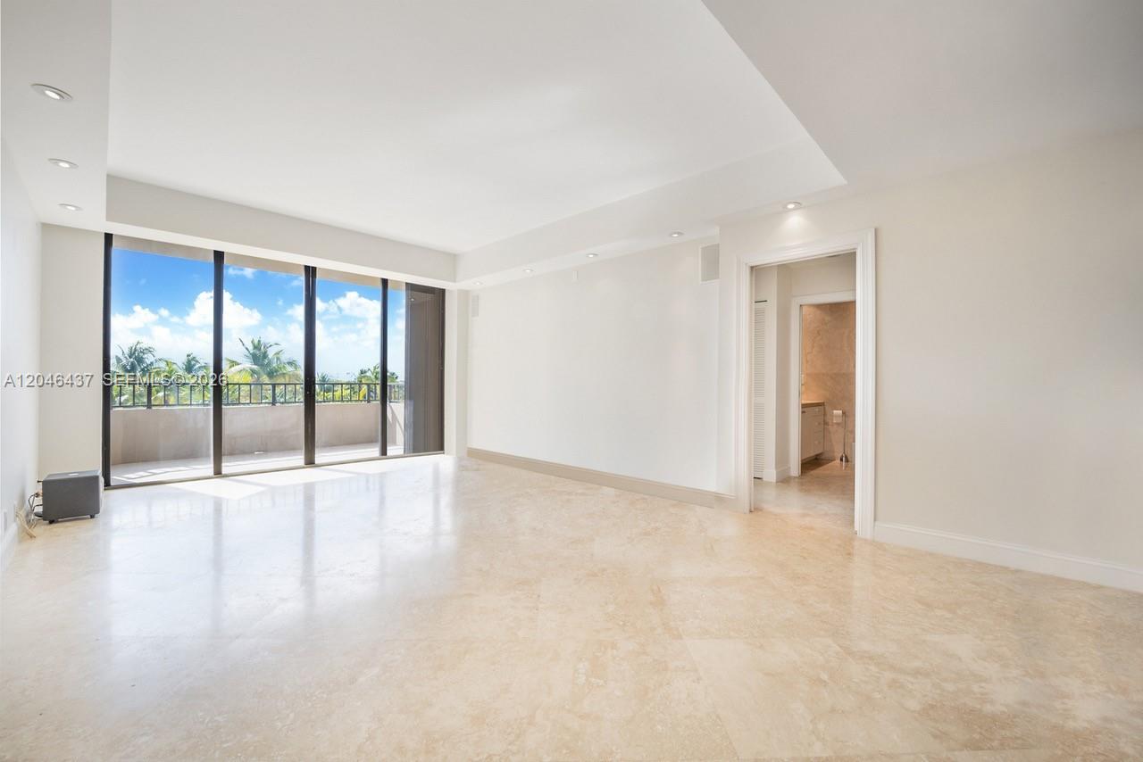 An empty room with light-colored tile flooring, recessed lighting, and a balcony with ocean views — 151 Crandon Blvd # 439, Key Biscayne FL 33149, KEY BISCAYNE, FL