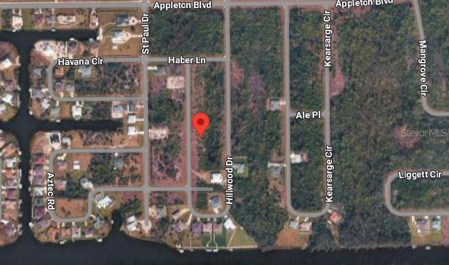 This is a satellite map view of a residential area with a red location pin — 10749 HILLWOOD DRIVE, PORT CHARLOTTE, FL