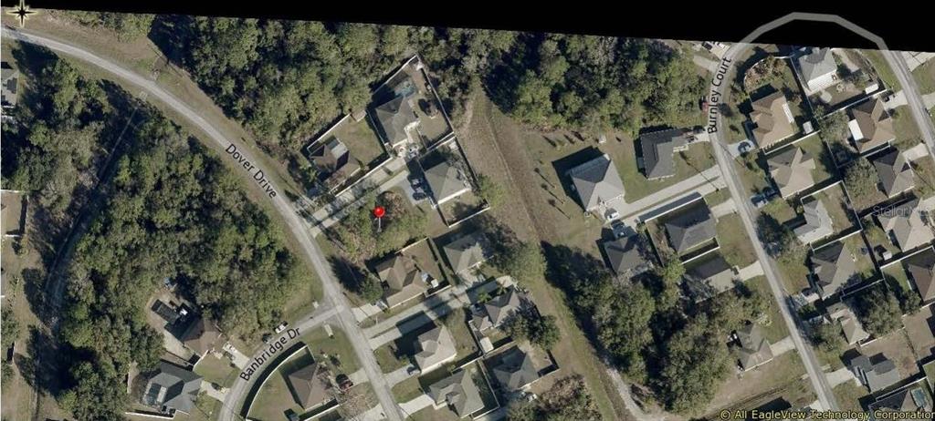 This is an aerial map view of a residential neighborhood with houses and wooded areas — DOVER DRIVE, KISSIMMEE, FL