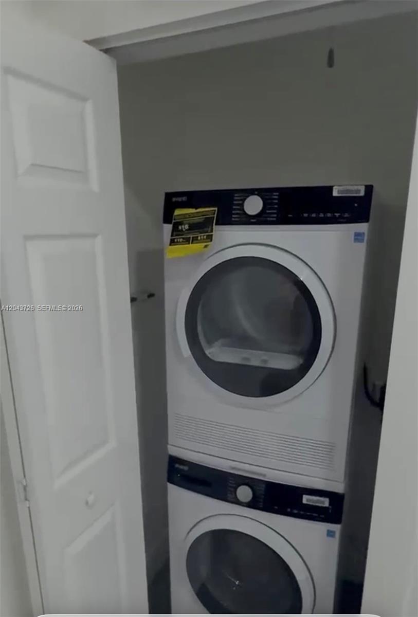 A stacked washer and dryer unit is installed inside a small white closet — 1895 SW 22nd # 7, Miami FL 33145, MIAMI, FL