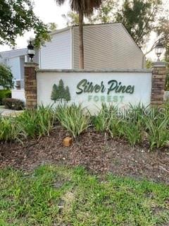 A stone and stucco sign for Silver Pines Forest stands in front of a building — 2112 NE 38TH AVENUE, OCALA, FL