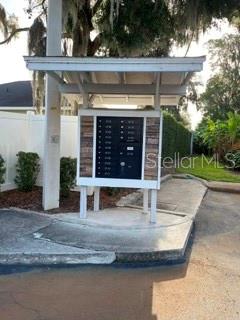 A cluster of metal mailboxes stands under a covered structure on a concrete pad — 2112 NE 38TH AVENUE, OCALA, FL