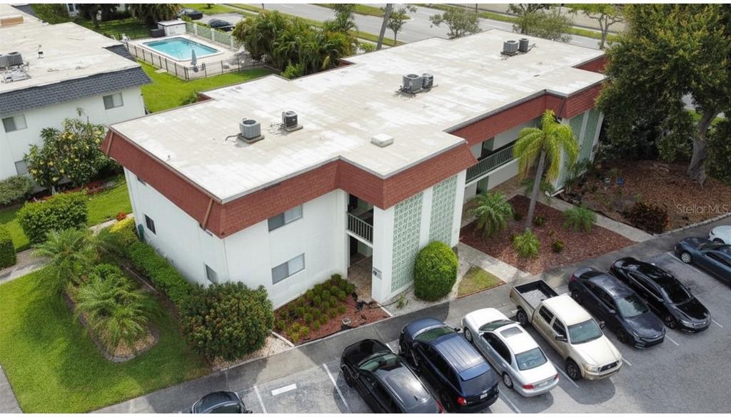 An aerial view shows a two-story apartment building with a flat roof and parking lot — 3606 BENEVA ROAD UNIT 504, SARASOTA, FL
