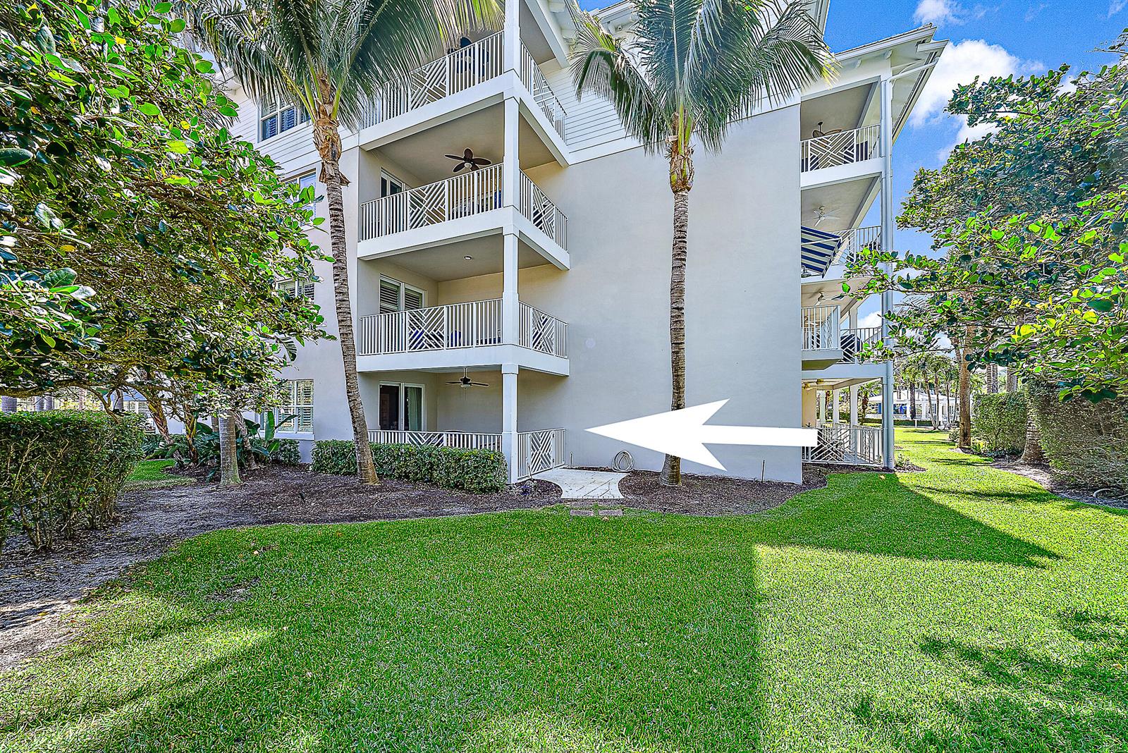 A ground-floor patio with a white railing and a ceiling fan at a multi-story building — 1015 Bay Colony Drive S Slip 17, Juno Beach FL 33408, JUNO BEACH, FL