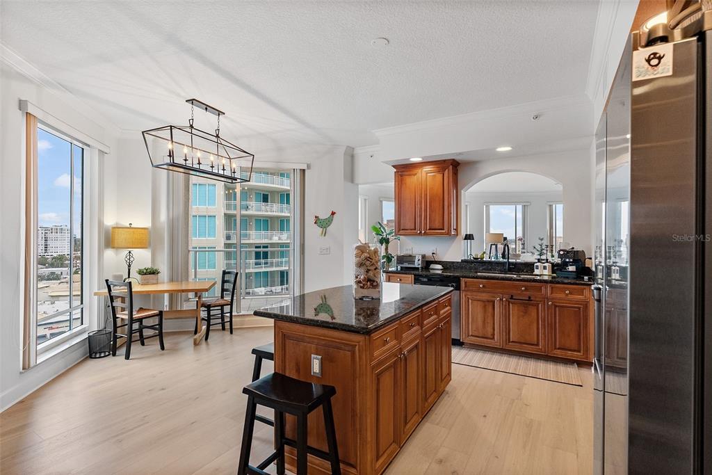 A bright foyer features light wood flooring, a console table with stools, and a hallway view — 100 BEACH DRIVE NE UNIT 1501, ST PETERSBURG, FL