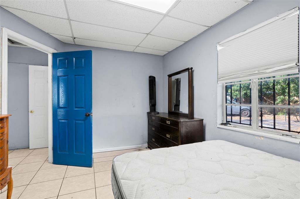 A kitchen features stainless steel appliances, light wood cabinets, tile flooring, and a drop ceiling — 110 N LINCOLN AVENUE, TAMPA, FL