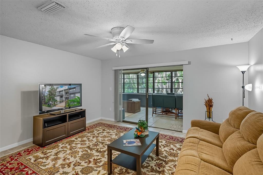 A dining area features a light wood table with four white chairs and tile flooring — 2746 SW 14 DRIVE UNIT 2746, GAINESVILLE, FL