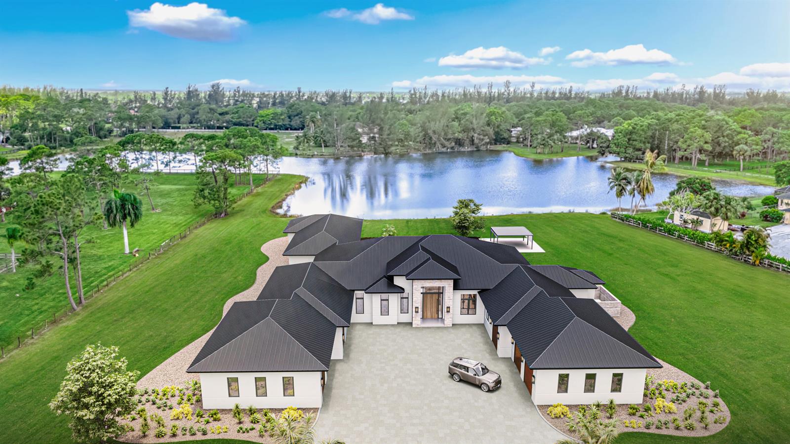 An aerial view shows a modern white house with a dark metal roof and driveway — 5593 Reynolds Road, Lake Worth FL 33449, LAKE WORTH, FL