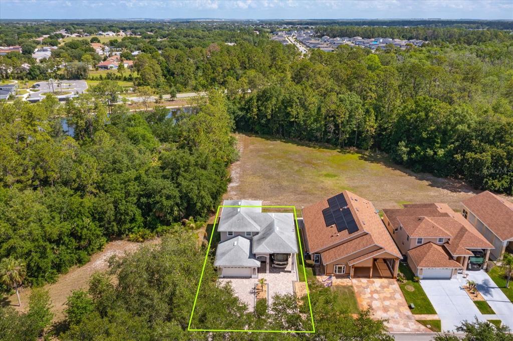 An aerial view shows a single-family home with a green outline on a suburban lot — 16201 CITRUS PKWY, CLERMONT, FL