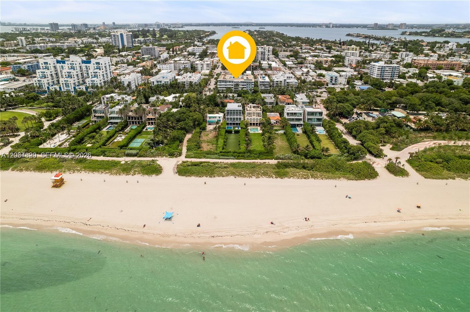 An aerial view shows a beachfront property with a modern house near the ocean — 7800 Collins Ave # 508, Miami Beach FL 33141, MIAMI BEACH, FL