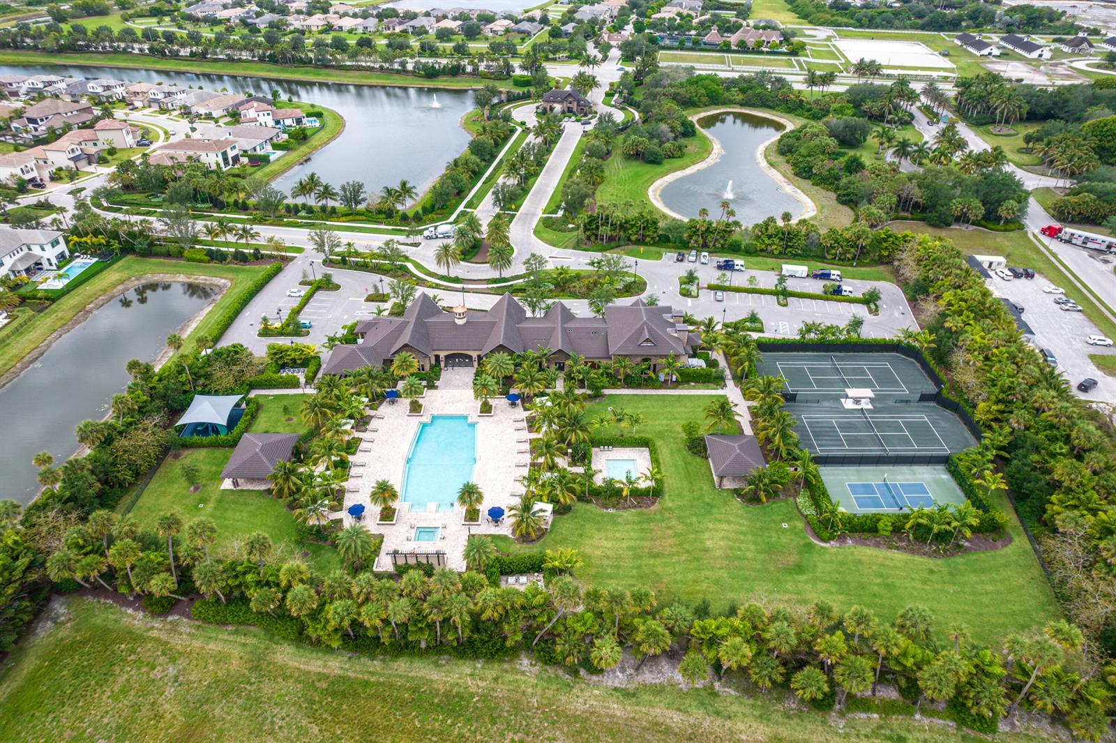 An aerial view of a community clubhouse featuring a swimming pool and tennis courts — 9091 Grand Prix Lane, Boynton Beach FL 33472, BOYNTON BEACH, FL