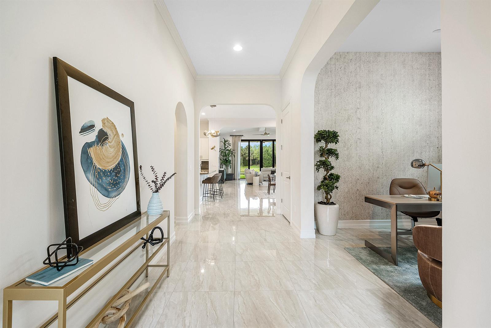 A bright hallway with marble-look tile flooring leads toward an open kitchen and living area — 9091 Grand Prix Lane, Boynton Beach FL 33472, BOYNTON BEACH, FL