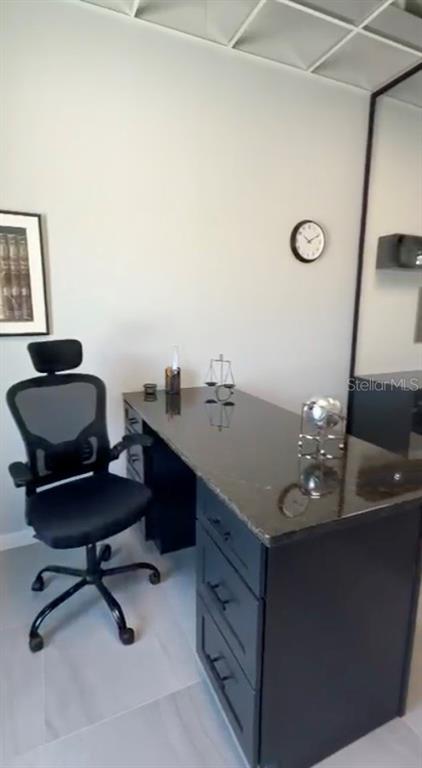 A modern lobby features a black marble reception desk, wood-slat walls, and a shuffleboard table — 4560 W IRLO BRONSON MEMORIAL HIGHWAY UNIT 203, KISSIMMEE, FL