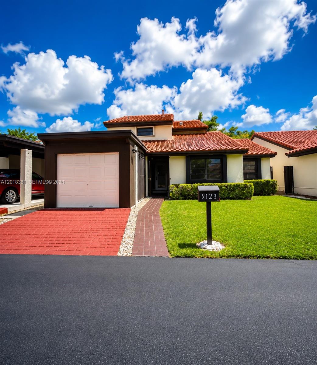 A single-story house with a red tile roof, white garage, and a red brick driveway — 9123 SW 112th Ct, Miami FL 33176, MIAMI, FL