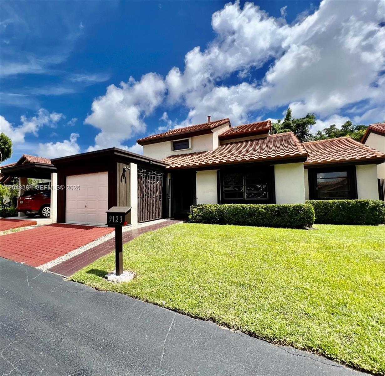 A single-story house with a tiled roof, a garage, and a front lawn — 9123 SW 112th Ct, Miami FL 33176, MIAMI, FL