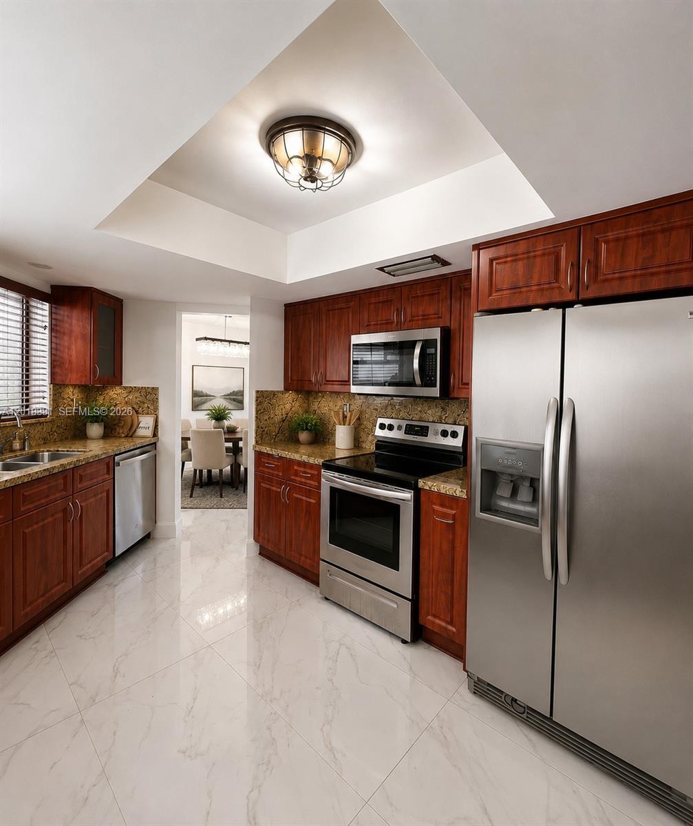 A kitchen features dark wood cabinets, stainless steel appliances, granite countertops, and white tile flooring — 9123 SW 112th Ct, Miami FL 33176, MIAMI, FL