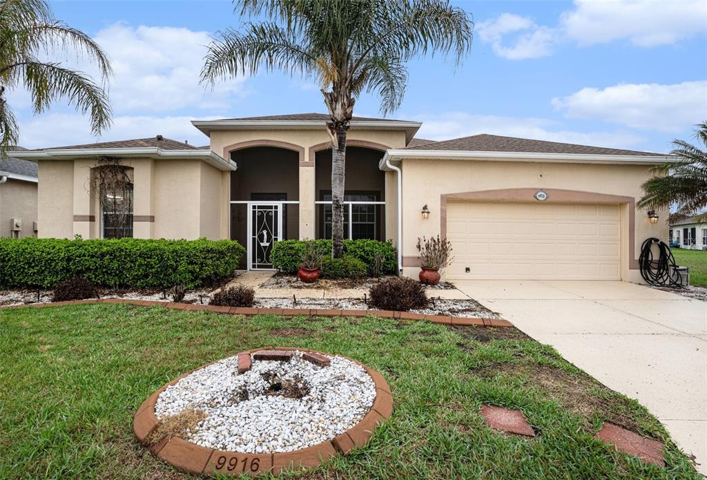 A kitchen features wood cabinets, granite countertops, stainless steel appliances, and a breakfast bar — 9916 CLEGHORN DRIVE, SAN ANTONIO, FL
