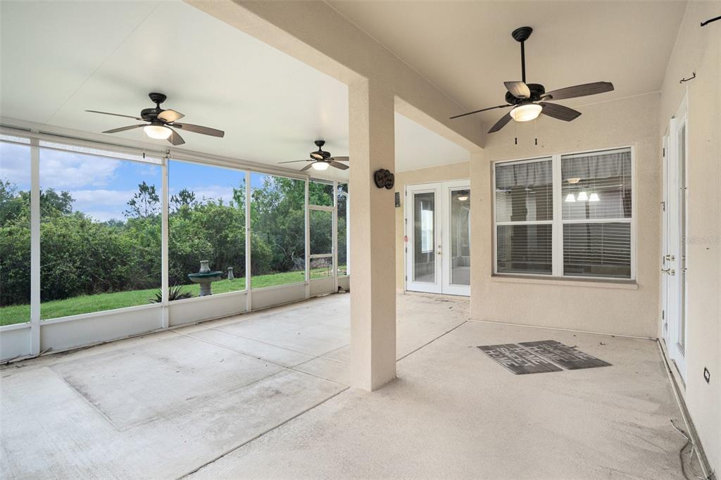 A kitchen features cherry wood cabinets, granite countertops, stainless steel appliances, and tile flooring — 9916 CLEGHORN DRIVE, SAN ANTONIO, FL