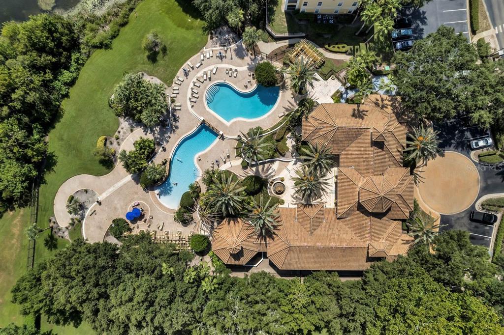 Aerial view of a large house with a multi-level swimming pool and surrounding landscaping — 1440 LAKE SHADOW CIRCLE UNIT 8201, MAITLAND, FL