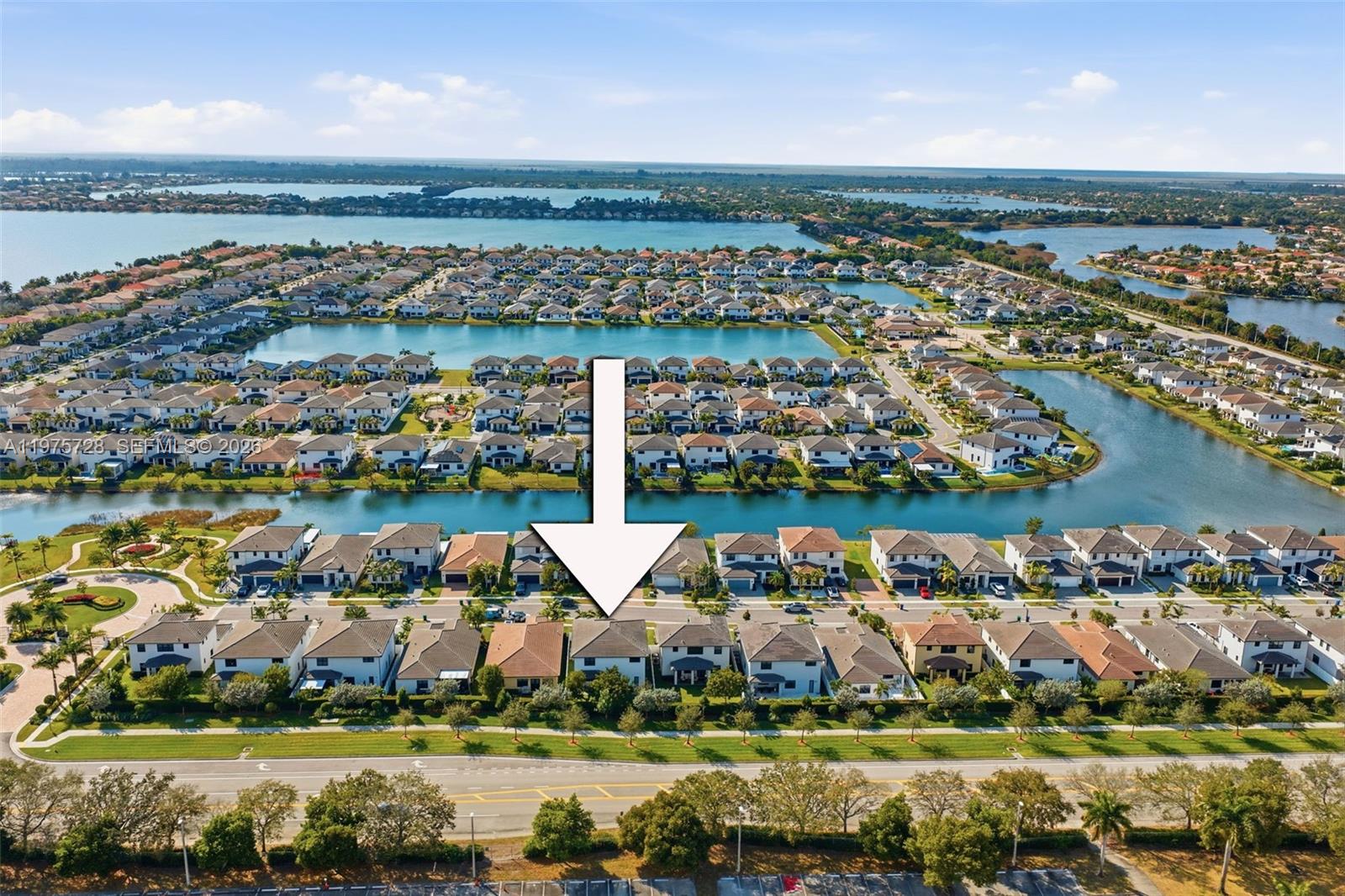 An aerial view shows a suburban neighborhood with houses bordering a lake — 4409 SW 173rd Ave, Miramar FL 33029, MIRAMAR, FL
